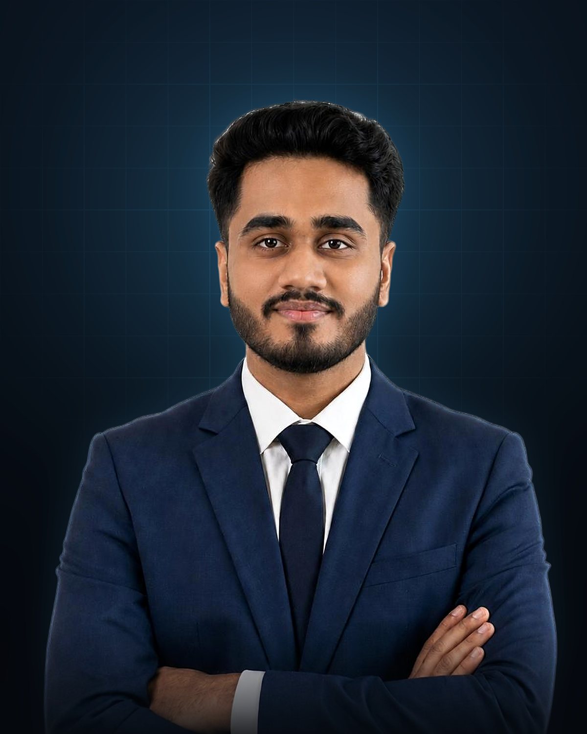 Portrait of Saurabh Sagar Shinde in a navy suit and tie, arms folded, smiling slightly.